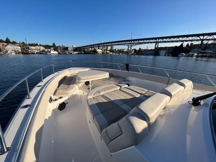  Yacht Photos Pics 2023 Boston Whaler 420 Outrage boat on calm water with bridge in background.