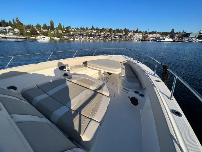  Yacht Photos Pics 2023 Boston Whaler 420 Outrage boat on calm water, featuring spacious deck seating.