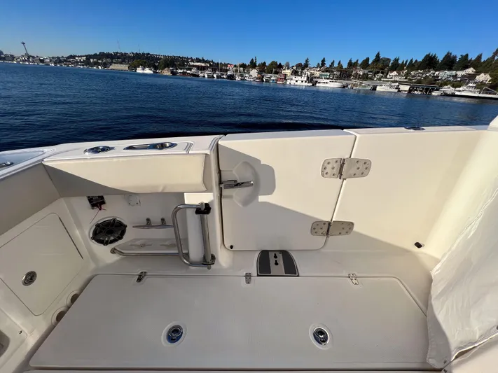  Yacht Photos Pics 2023 Boston Whaler 420 Outrage boat deck with scenic waterfront view.