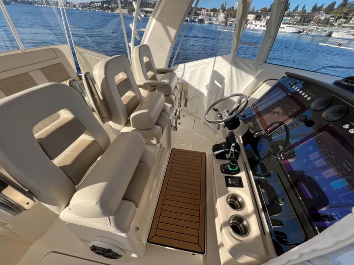  Yacht Photos Pics 2023 Boston Whaler 420 Outrage helm with modern controls and luxurious seating.