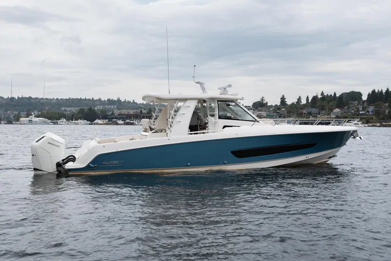  Yacht Photos Pics 2023 Boston Whaler 420 Outrage boat on calm water, side view.