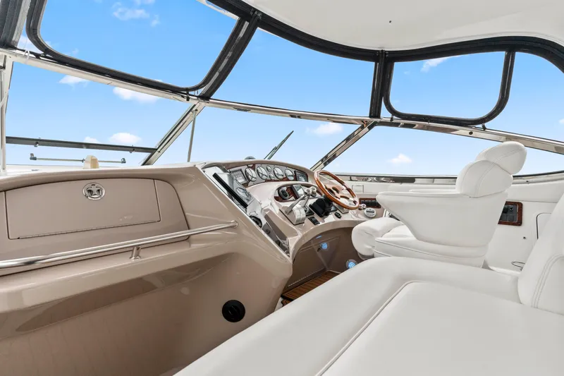 My Addiction Yacht Photos Pics 2001 Sea Ray Sundancer 510 helm with white seating and modern controls under blue sky.