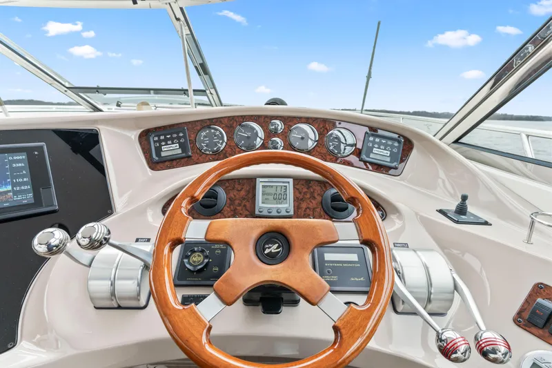 My Addiction Yacht Photos Pics Cockpit view of 2001 Sea Ray Sundancer 510 with wooden steering wheel and control panel.