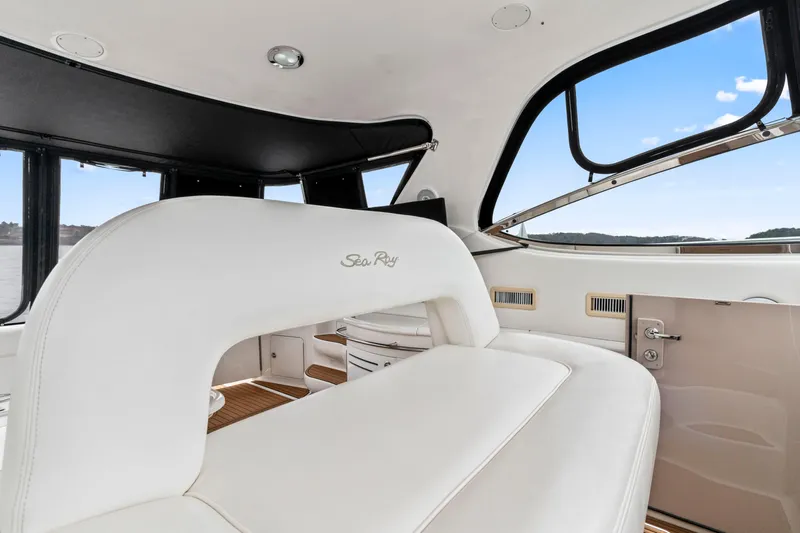 My Addiction Yacht Photos Pics Interior of 2001 Sea Ray Sundancer 510 yacht with white seating and panoramic windows.