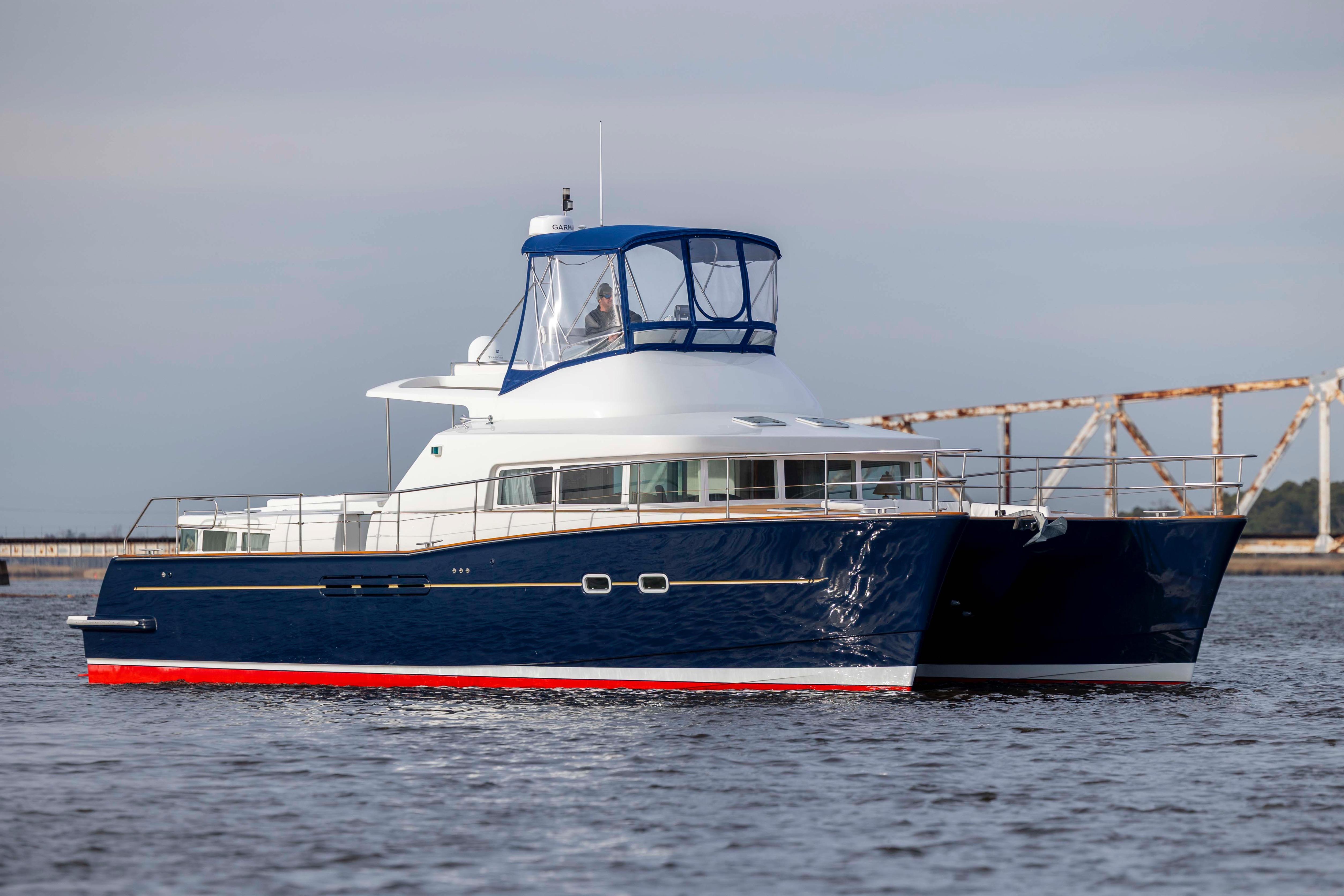 2004 Lagoon 43 PC yacht with blue hull and white superstructure on calm water.