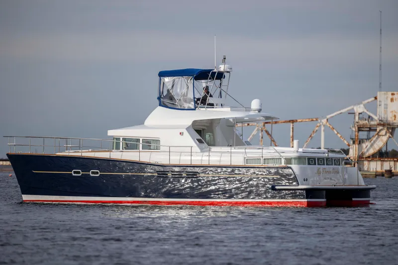  Yacht Photos Pics 2004 Lagoon 43 PC yacht on water, featuring sleek design and blue hull.