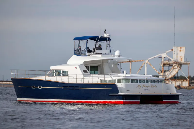  Yacht Photos Pics 2004 Lagoon 43 PC yacht cruising on water, featuring a sleek blue and white design.
