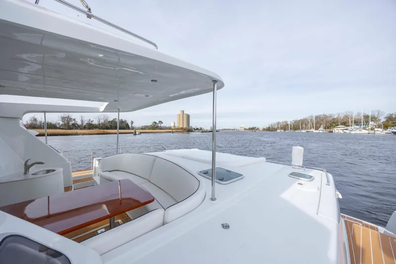  Yacht Photos Pics 2004 Lagoon 43 PC yacht with spacious deck and scenic waterway view.