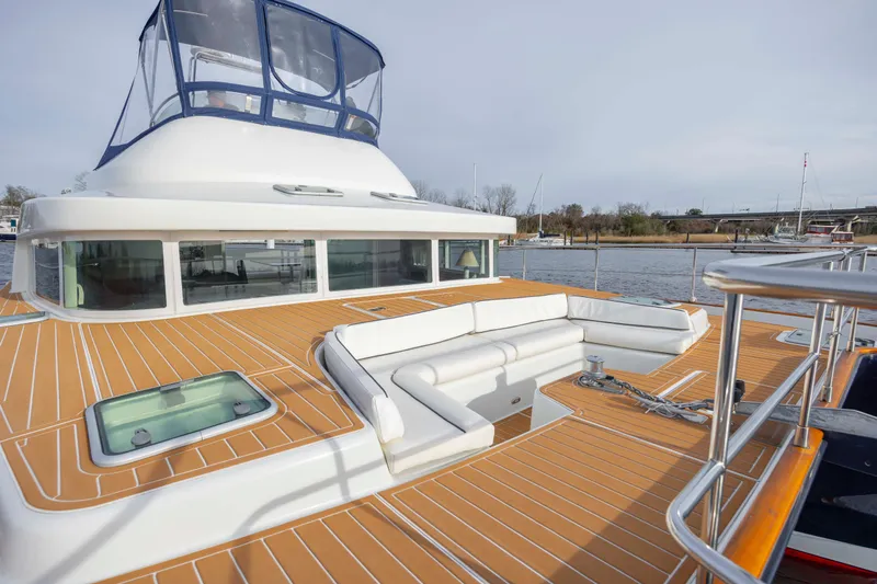  Yacht Photos Pics 2004 Lagoon 43 PC yacht with spacious deck and seating, docked by the water.