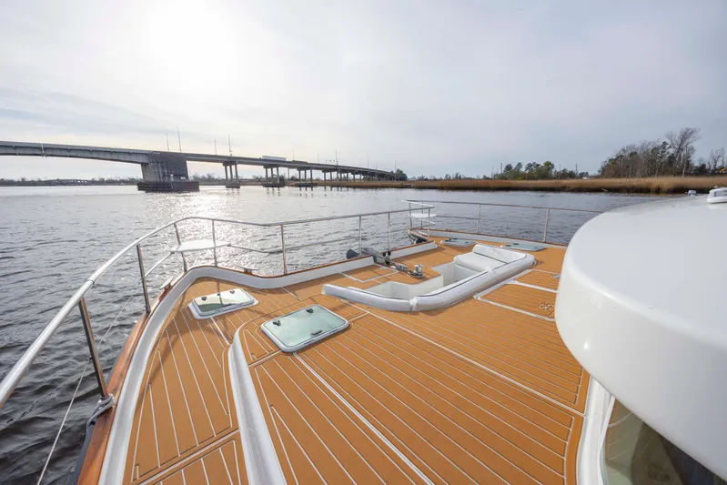  Yacht Photos Pics 2004 Lagoon 43 PC yacht deck with scenic river and bridge view.