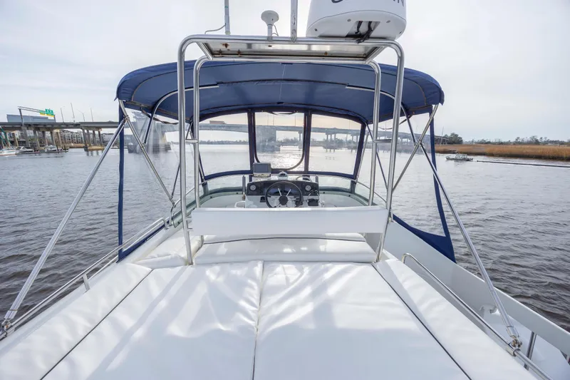  Yacht Photos Pics 2004 Lagoon 43 PC yacht with blue canopy on calm water.