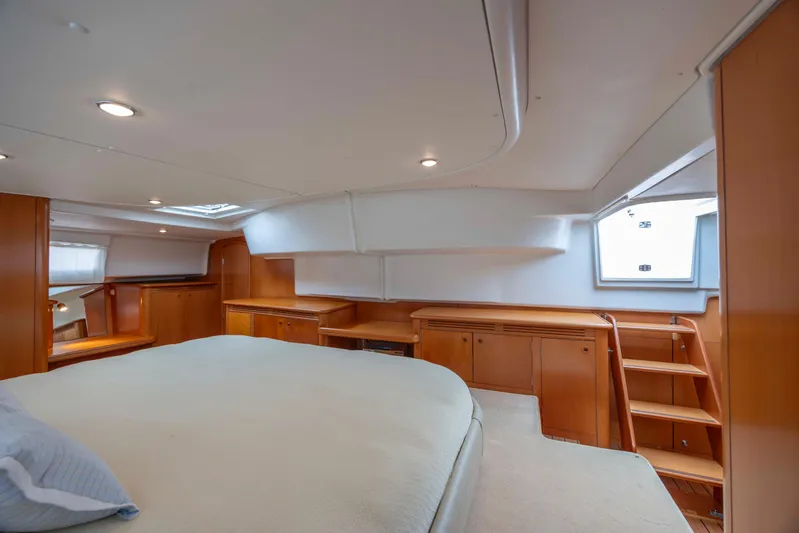  Yacht Photos Pics Luxurious cabin interior of 2004 Lagoon 43 PC yacht with wooden furnishings.