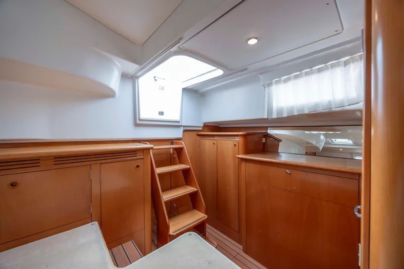  Yacht Photos Pics Interior of 2004 Lagoon 43 PC yacht with wooden cabinetry and natural light.