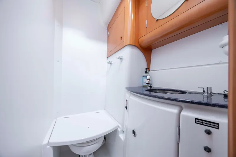 Yacht Photos Pics 2004 Lagoon 43 PC yacht bathroom with modern fixtures and wooden cabinetry.