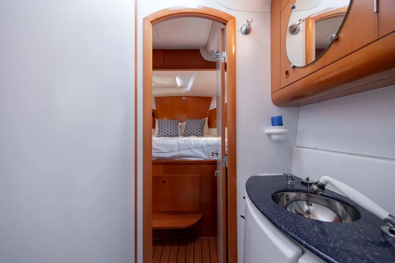  Yacht Photos Pics Interior of 2004 Lagoon 43 PC yacht, featuring cozy bedroom and modern bathroom.