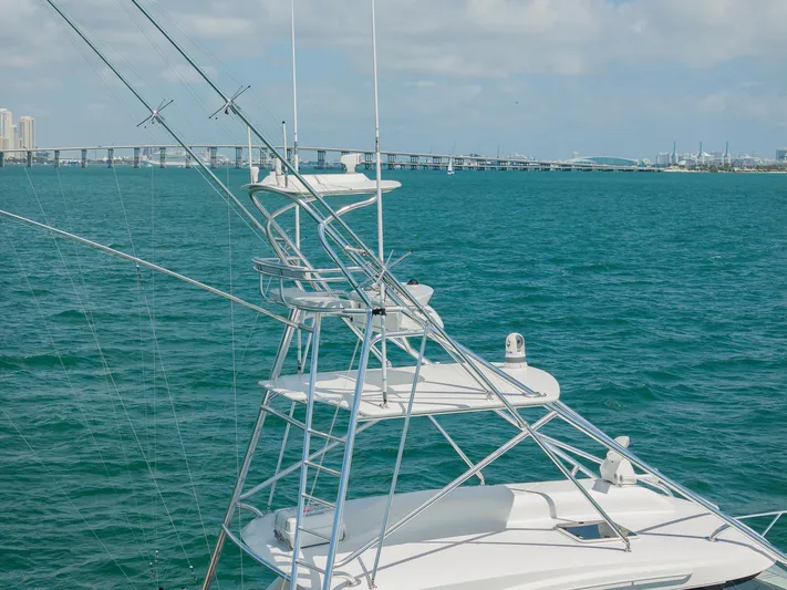  Yacht Photos Pics 2022 Bertram 50 yacht with tower against a scenic ocean backdrop.