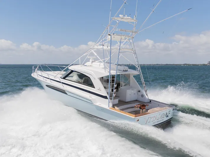  Yacht Photos Pics 2022 Bertram 50 yacht cruising on open water, showcasing sleek design and powerful performance.