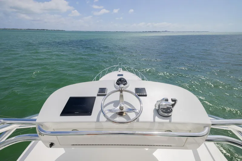  Yacht Photos Pics Helm of 2022 Bertram 50 yacht overlooking calm ocean waters.