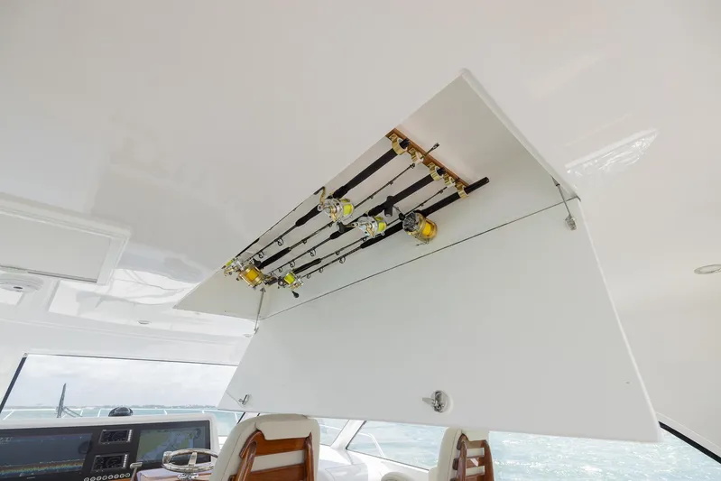  Yacht Photos Pics 2022 Bertram 50 yacht interior with fishing rods stored overhead.