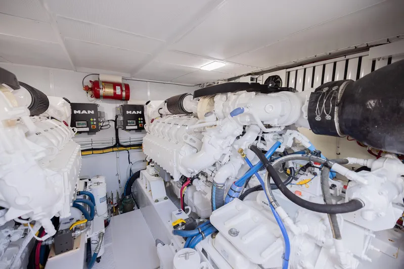  Yacht Photos Pics Engine room of a 2022 Bertram 50 yacht with MAN engines and fire extinguisher.
