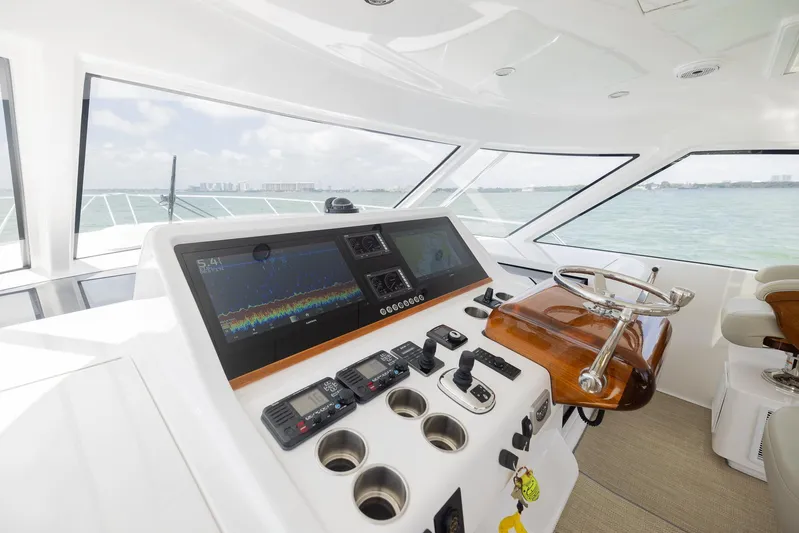  Yacht Photos Pics Helm of 2022 Bertram 50 yacht with modern navigation equipment and ocean view.