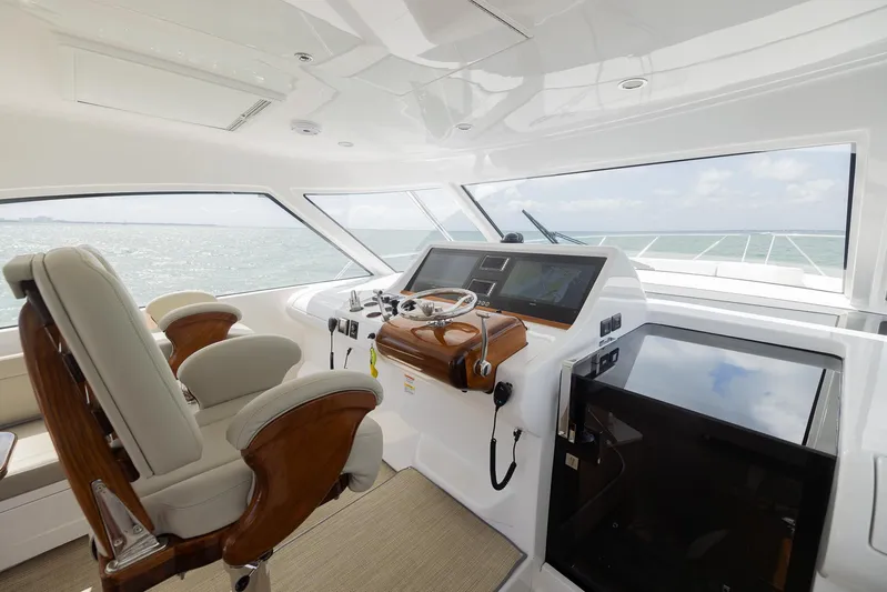  Yacht Photos Pics Luxurious 2022 Bertram 50 yacht helm with modern controls and plush seating.