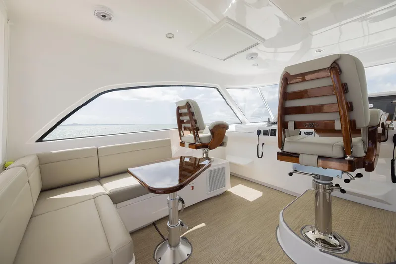  Yacht Photos Pics Luxurious interior of a 2022 Bertram 50 yacht with plush seating and modern helm chairs.