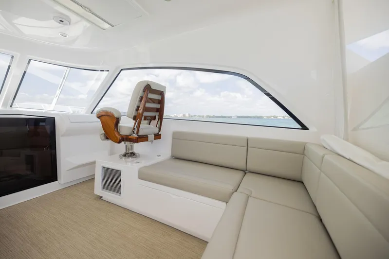  Yacht Photos Pics Luxurious interior of a 2022 Bertram 50 yacht with plush seating and panoramic windows.