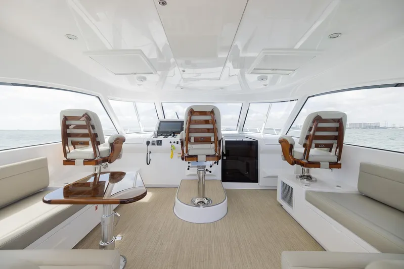  Yacht Photos Pics Interior of a 2022 Bertram 50 yacht with luxurious seating and helm.