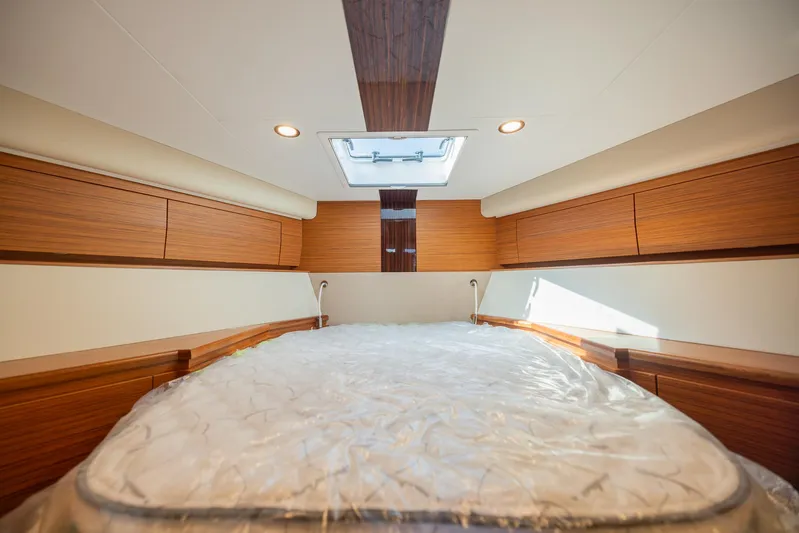  Yacht Photos Pics Luxurious interior of 2022 Bertram 50 yacht with wood finish and skylight.