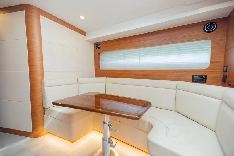  Yacht Photos Pics Luxurious interior of 2022 Bertram 50 yacht with elegant seating and wooden table.