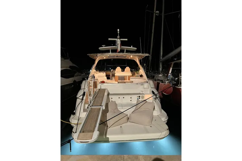  Yacht Photos Pics 2007 Cruisers Yachts 560 Express docked at night, illuminated with soft lighting.