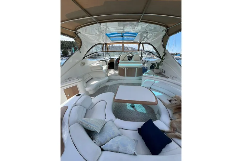  Yacht Photos Pics 2007 Cruisers Yachts 560 Express interior with seating, table, and dog lounging.