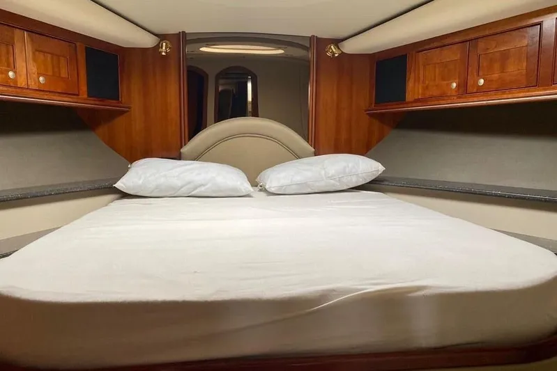  Yacht Photos Pics Luxurious cabin interior of 2007 Cruisers Yachts 560 Express with cozy bed and wooden cabinets.