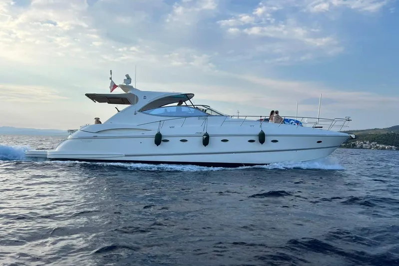  Yacht Photos Pics 2007 Cruisers Yachts 560 Express cruising on open water under a clear sky.