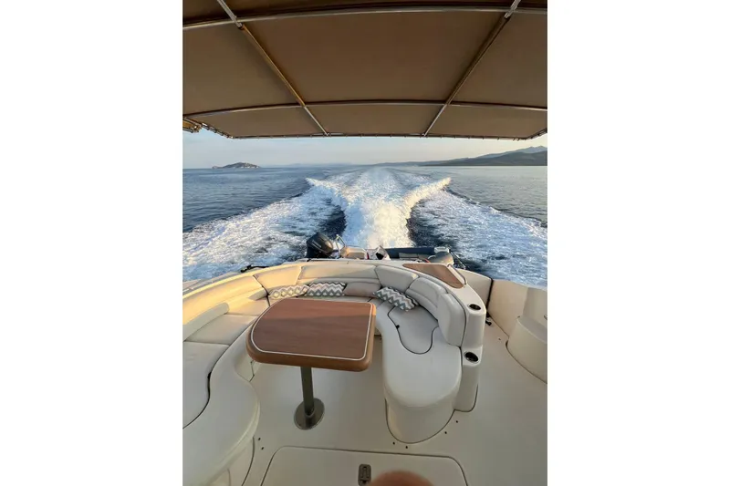  Yacht Photos Pics 2007 Cruisers Yachts 560 Express cruising on open water, featuring luxurious seating and table.