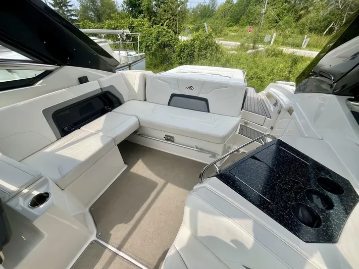  Yacht Photos Pics Interior of a 2012 Monterey 328 SS boat with white seating and black countertop.