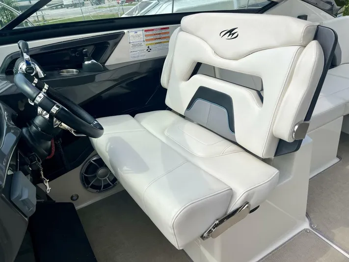  Yacht Photos Pics Captain's seat of a 2012 Monterey 328 SS boat, featuring white upholstery and sleek design.