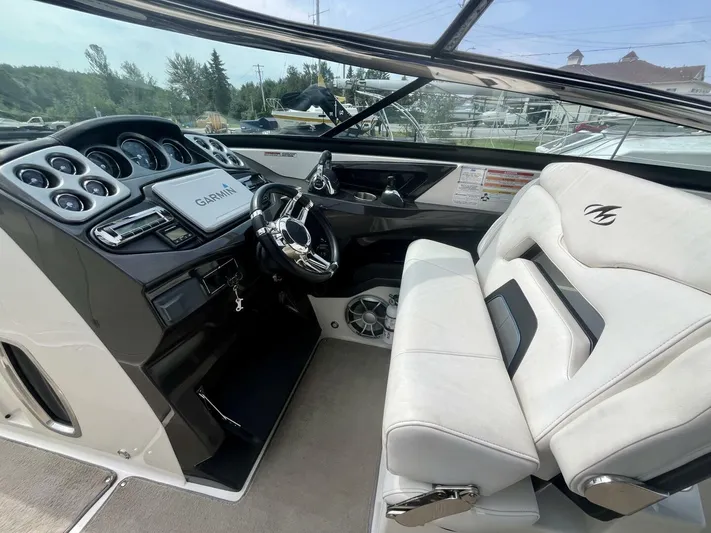  Yacht Photos Pics Interior of a 2012 Monterey 328 SS boat with white seating and modern dashboard.