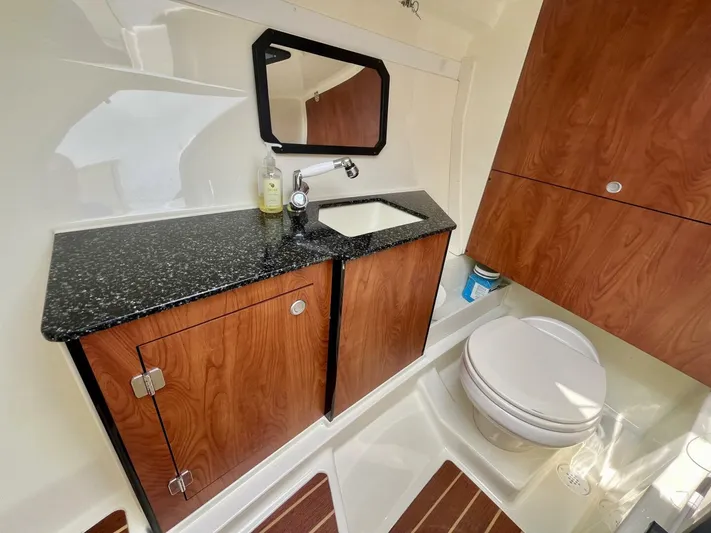  Yacht Photos Pics Luxurious 2012 Monterey 328 SS boat bathroom with wood cabinets and granite countertop.
