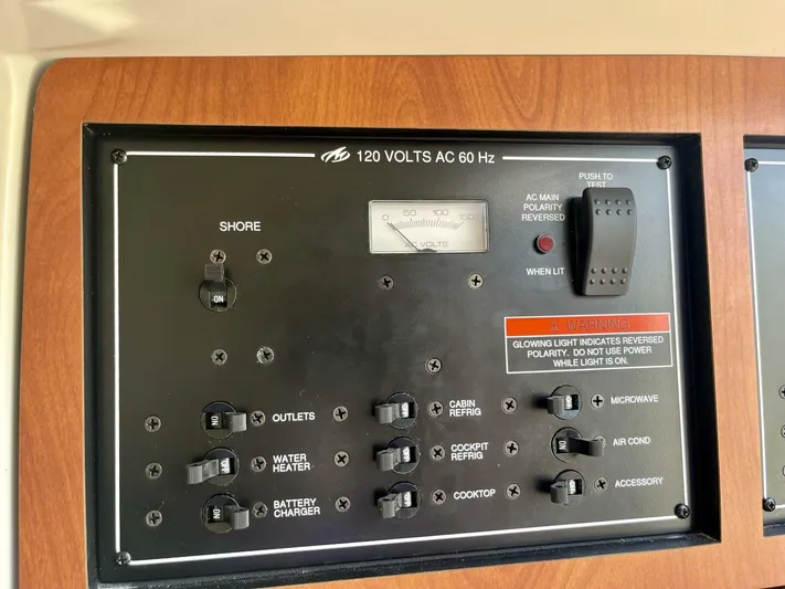  Yacht Photos Pics Electrical control panel of a 2012 Monterey 328 SS boat, featuring various switches and indicators.