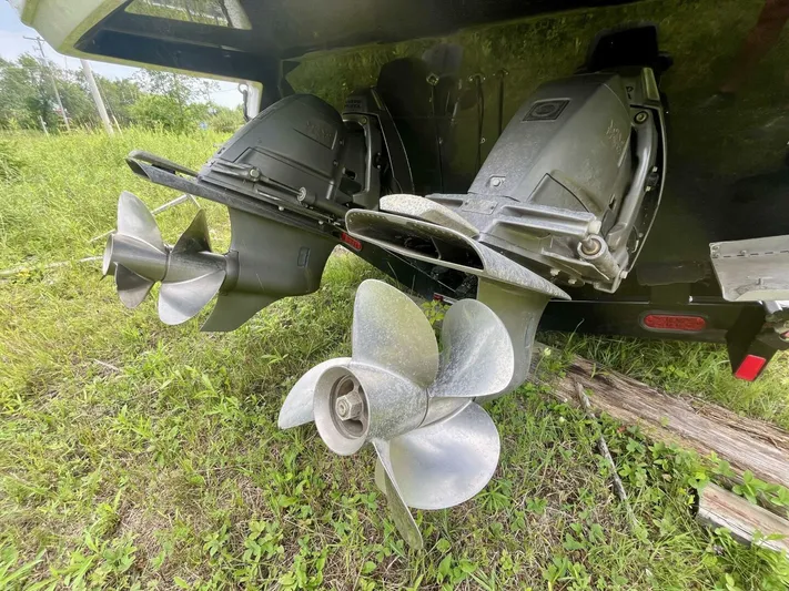  Yacht Photos Pics Dual propellers of a 2012 Monterey 328 SS boat on grassy terrain.