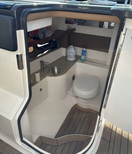  Yacht Photos Pics 2014 Sea Ray 350 SLX boat interior with compact bathroom, sink, and toilet.