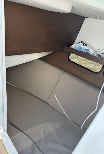  Yacht Photos Pics Interior cabin of 2014 Sea Ray 350 SLX boat, featuring cozy seating and storage.