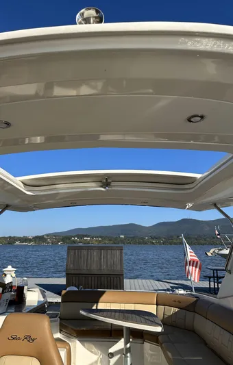  Yacht Photos Pics 2014 Sea Ray 350 SLX boat interior with open roof, lake view, and American flag.