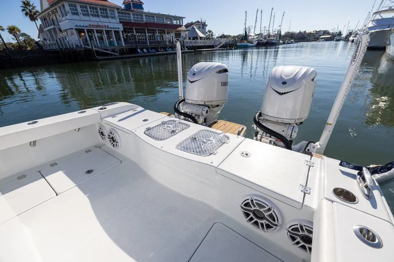  Yacht Photos Pics 2024 Freeman 28 boat with dual engines docked near waterfront restaurant.