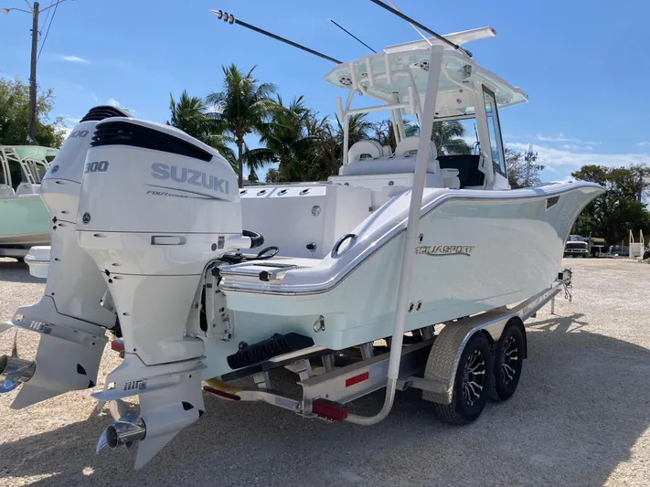  Yacht Photos Pics 2025 Aquasport 28AS boat with dual Suzuki engines on a trailer, parked outdoors.