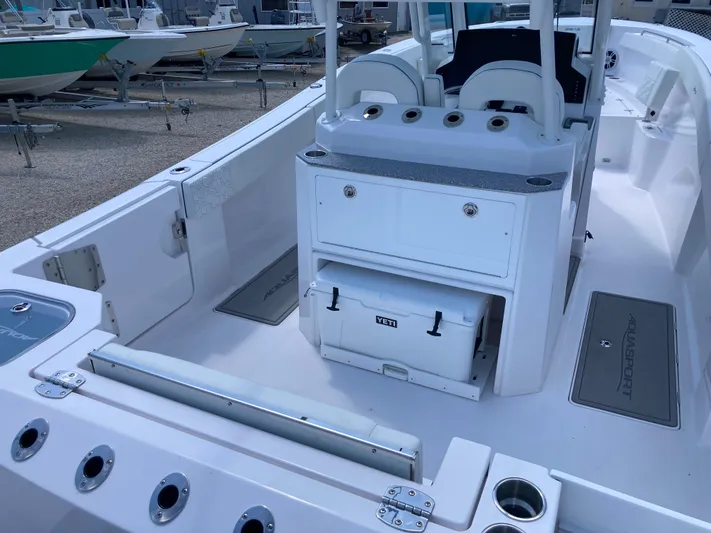  Yacht Photos Pics 2025 Aquasport 28AS boat interior with seating, storage, and cooler on deck.