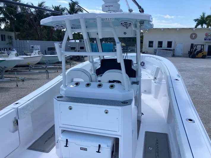 Yacht Photos Pics 2025 Aquasport 28AS boat with center console and seating, docked in a marina.