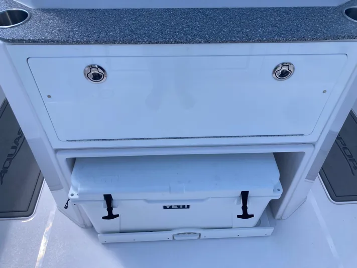  Yacht Photos Pics 2025 Aquasport 28AS boat storage compartment with cooler and countertop.